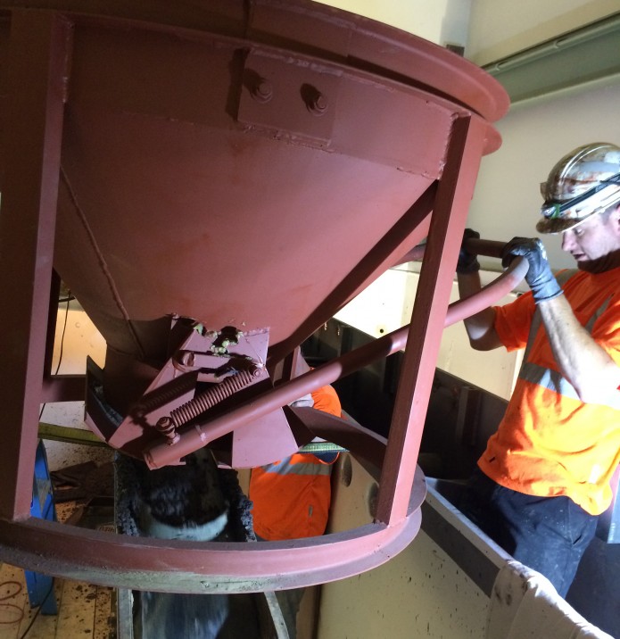 A worker pours high-density concrete at the CANS-PIE facility on September 24th, 2014. (Photo Credit: Ken Johnson, IMC Project Manager)